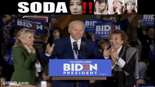 Joe Biden Is Giving A Speech In Front Of A Crowd With A Sign That Says Biden President GIF