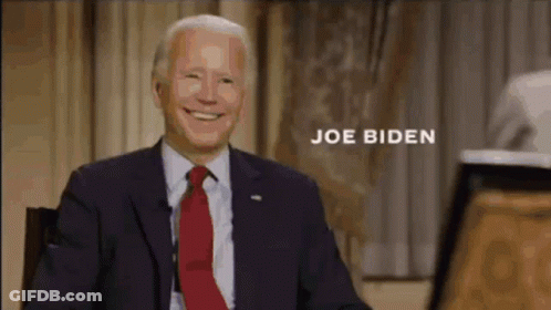 Joe Biden Smiling While Sitting In Chair In Front Of Microphone GIF