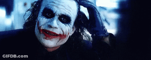 Joker From The Dark Knight Rises Holding Hand To Head GIF