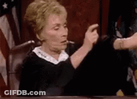 Judge Giving Thumbs Up In Front Of American Flag GIF