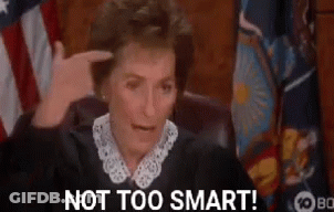 Judge Pointing At Head In Front Of American Flag GIF