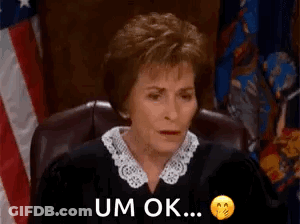 Judge Sitting In Front Of American Flag GIF