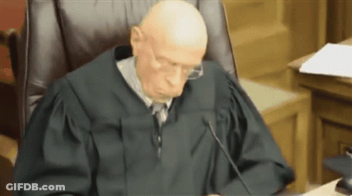 Judge With Glasses In Courtroom GIF