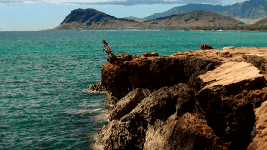 Jumping Off A Cliff By The Water GIF
