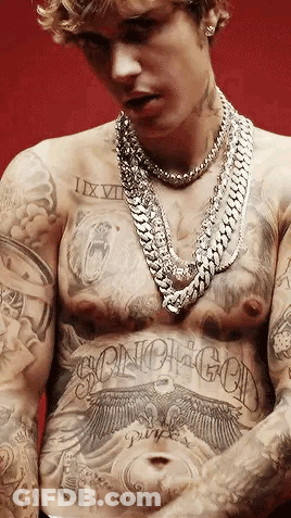 Justin Bieber Has A Lot Of Tattoos On His Chest And Torso . GIF
