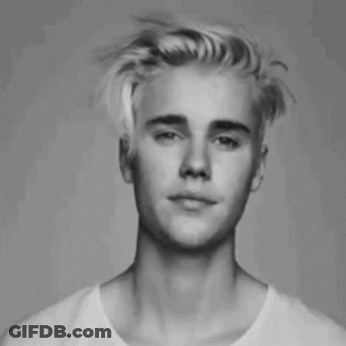 Justin Bieber In His Messy Hair And Winking GIF