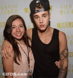 Justin Bieber Is Posing For A Picture With A Girl GIF