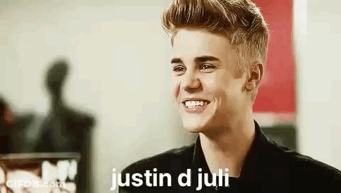 Justin Bieber Is Smiling While Wearing A Black Jacket And A Black Shirt . GIF