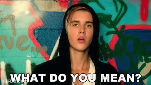 Justin Bieber Is Wearing A Hooded Jacket And Asking What Do You Mean GIF