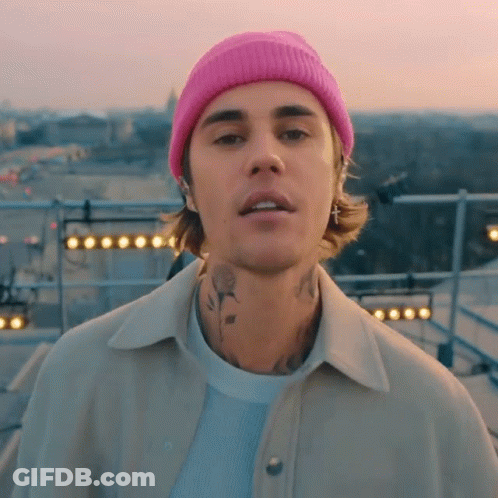 Justin Bieber Is Wearing A Pink Beanie And Earrings GIF