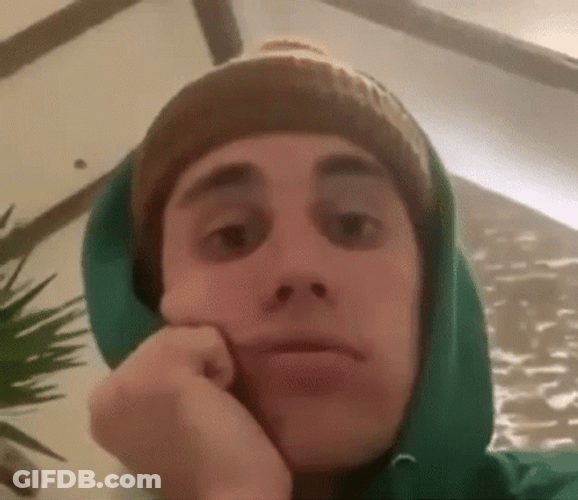 Justin Bieber With His Hands On His Cheek GIF