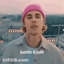 Justin D Julii Is Wearing A Pink Beanie And A White Shirt . GIF