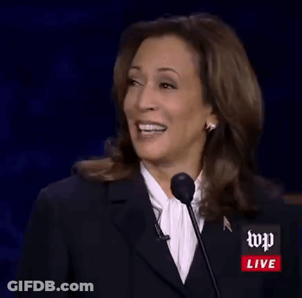 Kamala Harris Is Smiling While Giving A Speech At A Podium . GIF