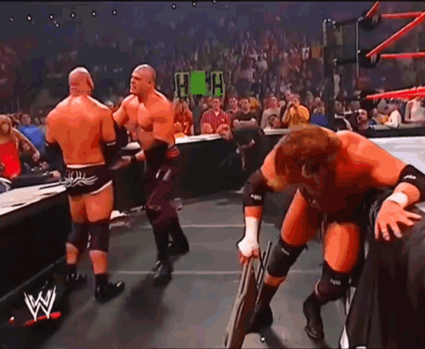 Kane Chokeslam Goldberg On Announcers Table GIF