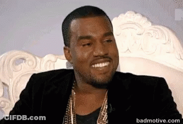 Kanye West Is Smiling While Sitting On A Couch . GIF