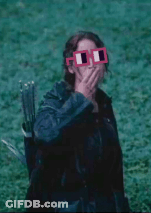 Katniss Everdeen Raising Fingers In Glasses GIF