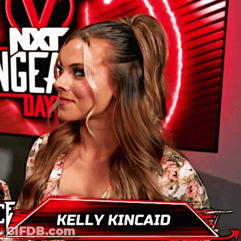 Kelly Kincaid Standing Before Red Next Gen Day Sign GIF