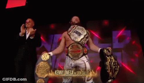 Kenny Omega Holding Two Championship Belts GIF