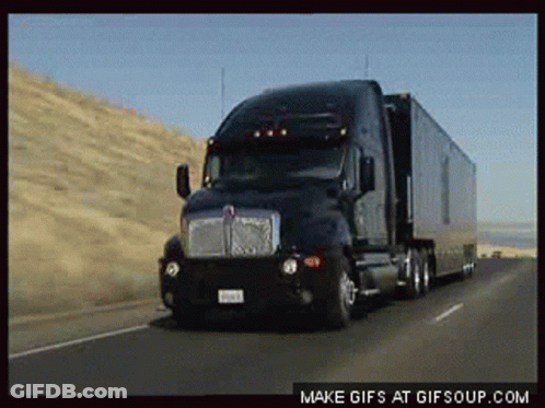 Kenworth Semi Truck Driving Down Highway GIF