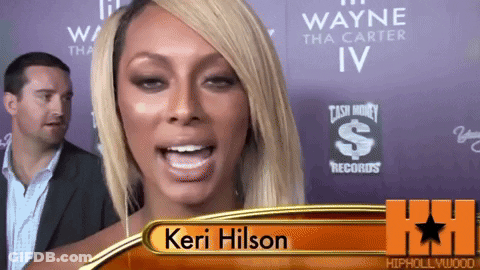Keri Hilson Standing In Front Of Cash Money Records Sign GIF