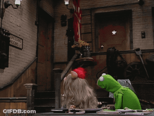 Kermit And Miss Piggy Sitting At Table Beside Dressing Room Sign GIF