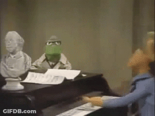 Kermit Playing Piano In Front Of Statue GIF