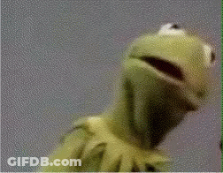 Kermit The Frog From Sesame Street Is Looking At The Camera With His Mouth Open . GIF