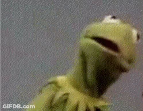 Kermit The Frog From Sesame Street Is Looking At The Camera With His Mouth Open . GIF