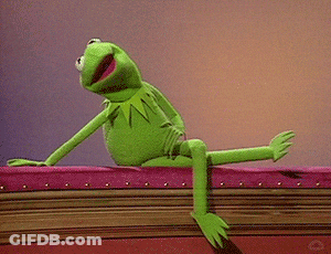 Kermit The Frog From Sesame Street Is Sitting On A Pink Couch . GIF