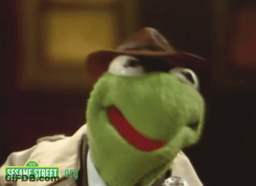 Kermit The Frog From Sesame Street Wearing A Hat And A Trench Coat GIF