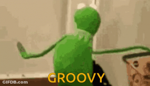 Kermit The Frog Is Dancing In A Room With The Words `` Groovy '' Written On The Bottom . GIF