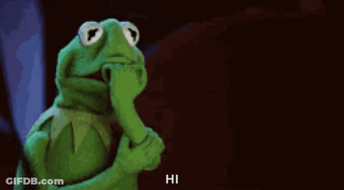 Kermit The Frog Is Holding His Hand To His Mouth And Says Hi . GIF