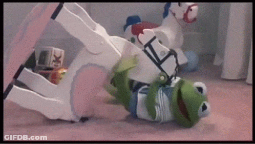 Kermit The Frog Is Playing With A Rocking Horse On The Floor . GIF