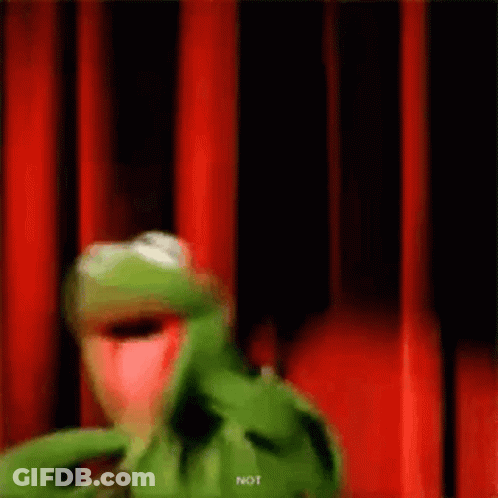 Kermit The Frog Is Standing In Front Of A Red Curtain And Making A Funny Face . GIF
