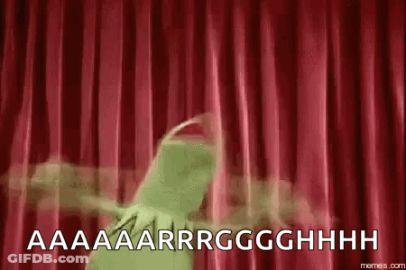 Kermit The Frog Is Standing In Front Of A Red Curtain And Screaming . GIF