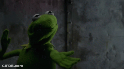 Kermit The Frog Is Standing In Front Of A Wall With His Mouth Wide Open GIF