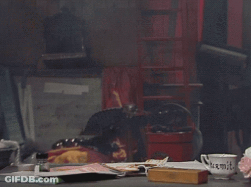 Kermit The Frog Sits At A Table With Two Stuffed Animals And A Mug That Says " Kermit " GIF