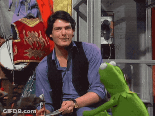 Kermit The Frog Sits Next To A Man In A Purple Shirt GIF