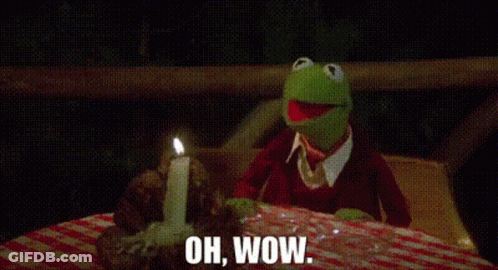 Kermit The Frog Sitting At Table With Candle Saying Oh Wow GIF