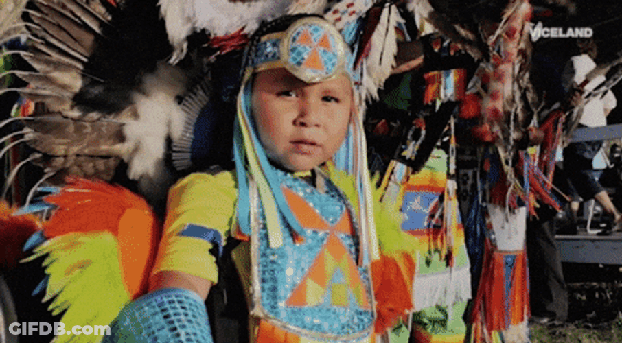 Kid As Tribal Chief Handing Stick GIF