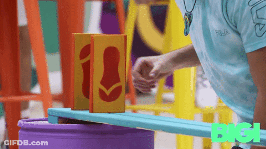 Kid Lining Up Domino Tiles GIF