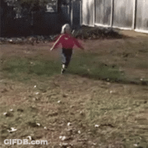 Kid Playing Piled Falling Leaves GIF