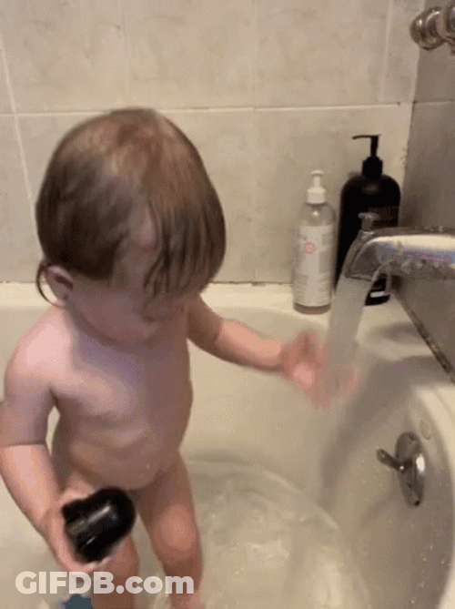 Kid Plays Water During Bath Time GIF
