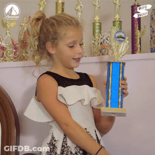 Kid Showing Off Trophy GIF