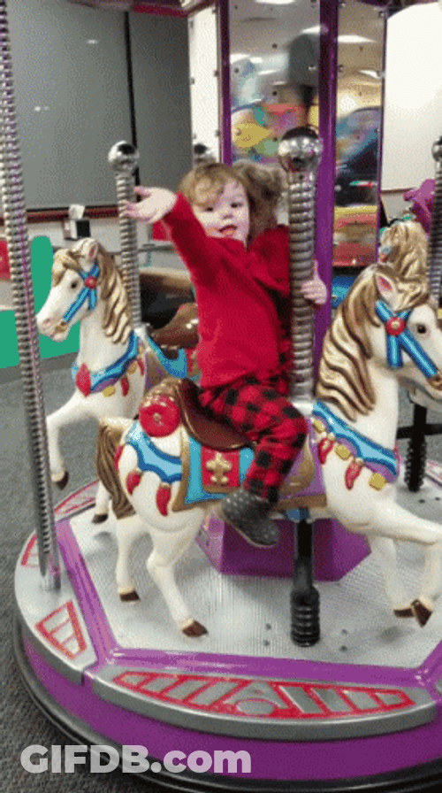 Kid Waving From Merry Go Round GIF