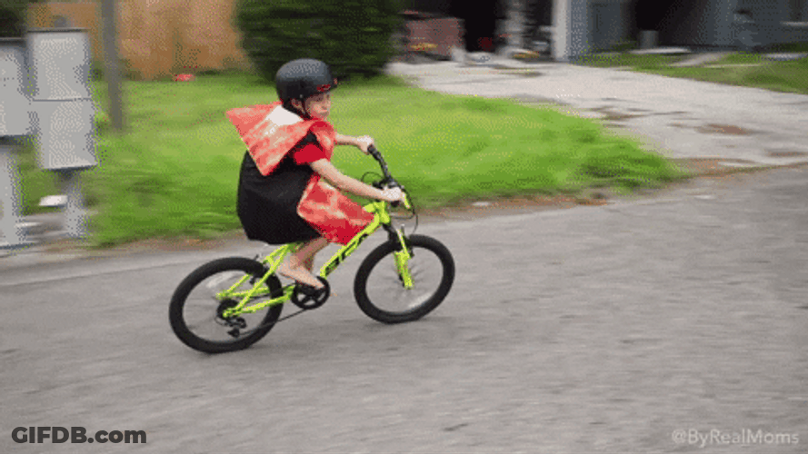 Kid Wearing Pizza Costume Riding Bike GIF