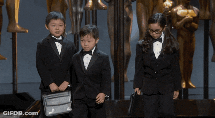 Kids Wearing Tuxedo And Carrying Briefcase GIF