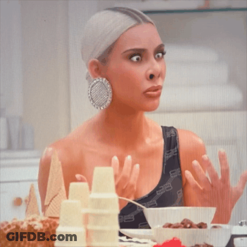 Kim Kardashian Is Sitting At A Table With Cereal And Ice Cream Cones GIF