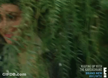 Kim Kardashian Is Smiling While Standing In A Forest GIF