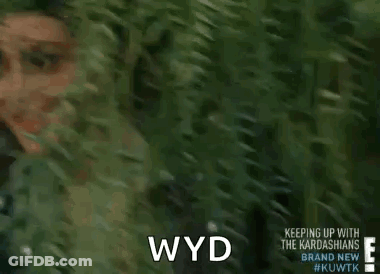 Kim Kardashian Smiling In Front Of Bush GIF